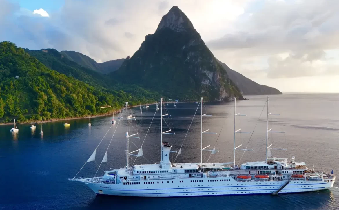 Pictoresque Soufriere with a luxury ship and Piton in the background.