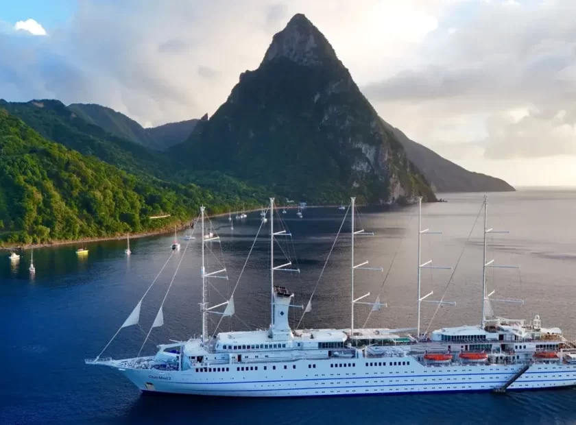 Pictoresque Soufriere with a luxury ship and Piton in the background.