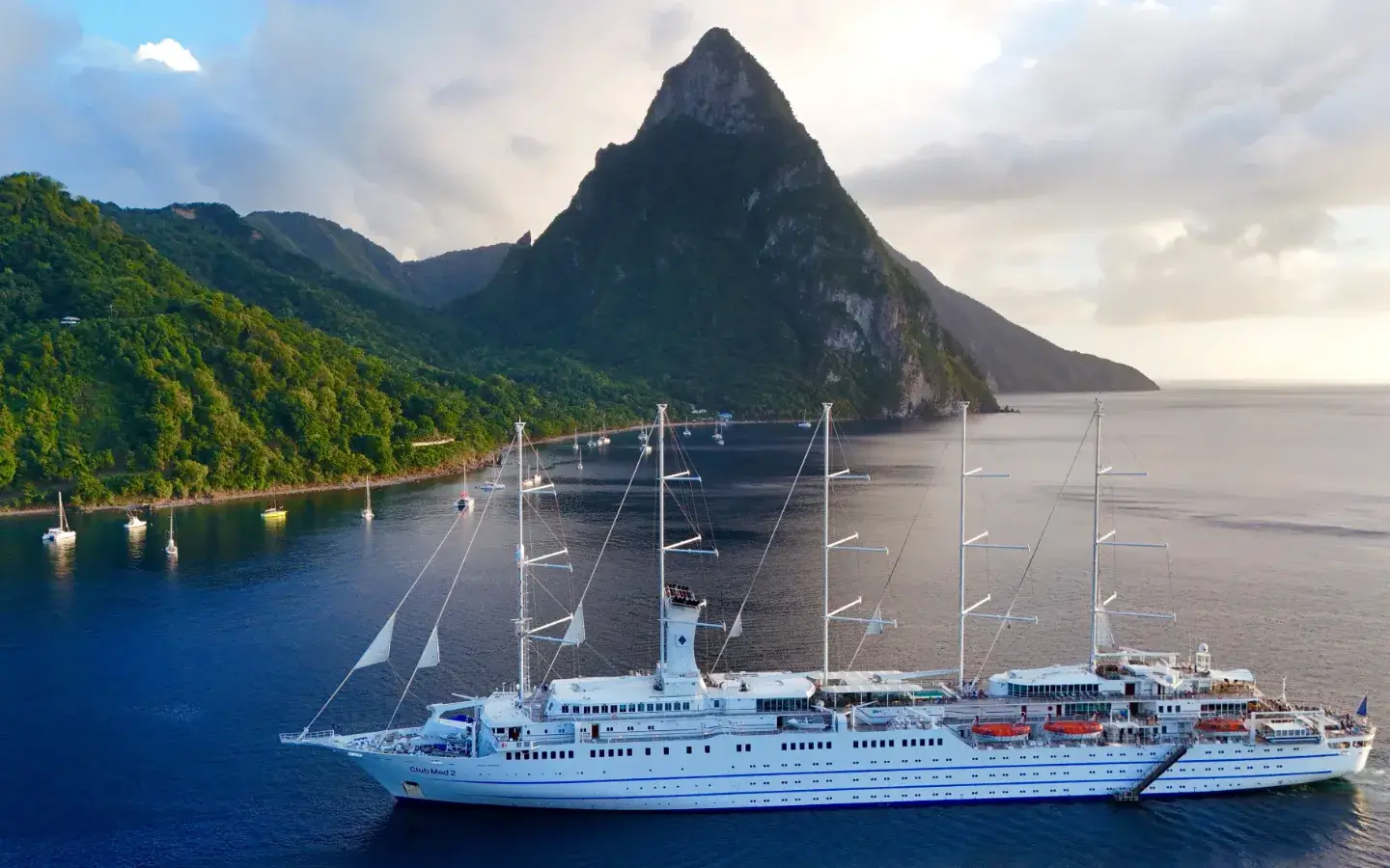 Pictoresque Soufriere with a luxury ship and Piton in the background.